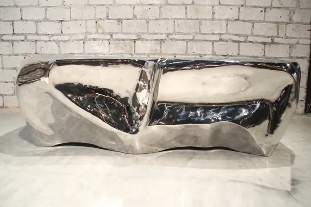 Close-up of the mirror polished surface of a hand forged coffee table