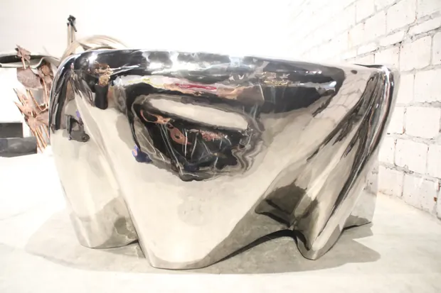 Stainless steel coffee table placed in a hotel lounge with reflective finish
