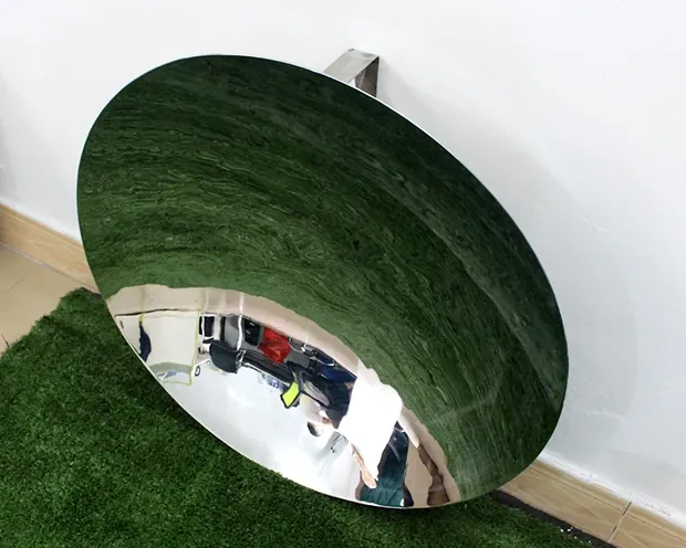 Stainless steel mirror sculpture in a shopping mall corridor, reflecting movement and light