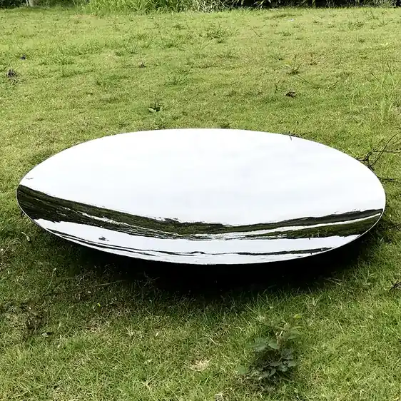 Group of mirror-polished stainless steel hemispheres on a building facade