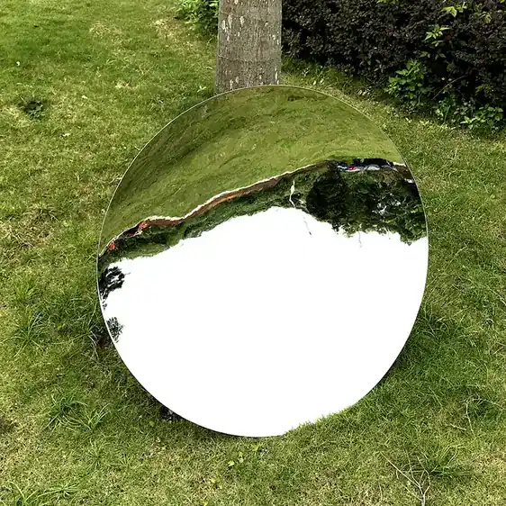Freestanding stainless steel mirror hemisphere in a modern interior space