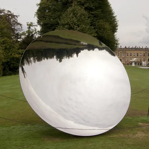 Side view of a concave mirror sculpture showing its depth and curvature