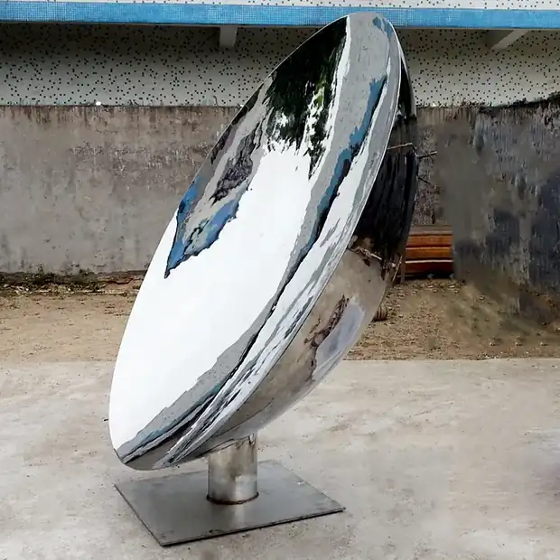 Close-up of a mirror polished concave sculpture showing surface detail