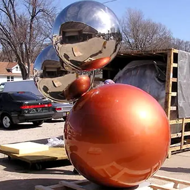 Blue decorative ball in a landscape setting near a building entrance