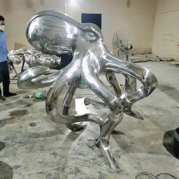 Side view of the octopus sculpture showing the hollow forged body and welded seams