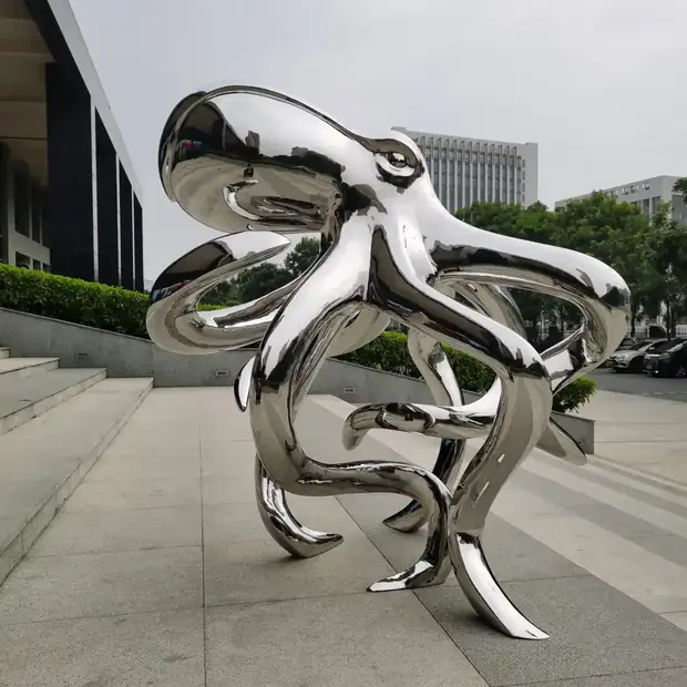 Close-up of mirror polished stainless steel octopus sculpture showing surface detail and reflections