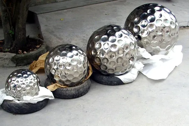 Cluster of mirror polished stainless steel spheres arranged in a geometric pattern