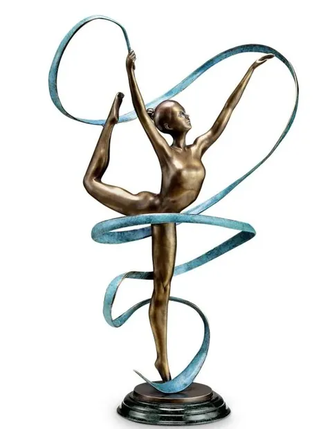Cast copper sculpture of a dancing man on a wooden desk