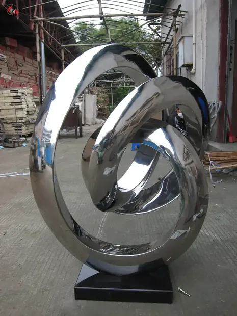 Abstract ribbon sculpture in mirror polished 304 stainless steel, flowing through space