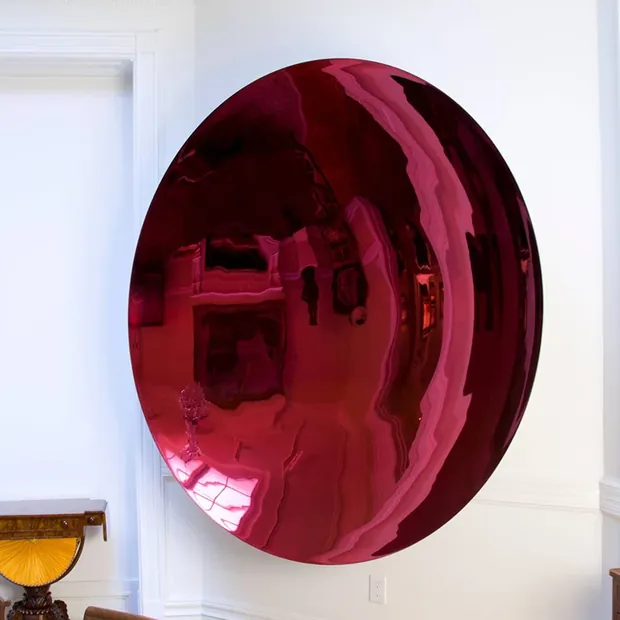 Group of stainless steel ball tops in different finishes on a gallery wall