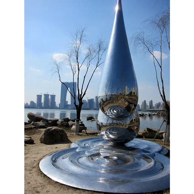 Close-up of a stainless steel droplet showing the pointed tip and smooth form