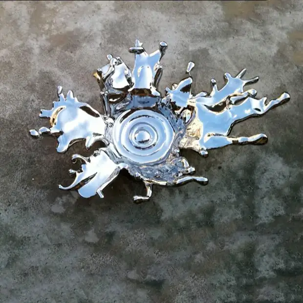 Close-up of a hand forged stainless steel spray sculpture with smooth curved edges