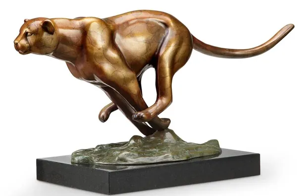 Brass cheetah sculpture in natural finish with a reflective surface