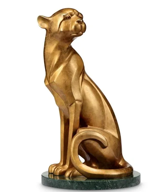 Three brass cast cheetahs arranged on a display cabinet