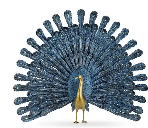 Brass cast peacock screen with detailed feather forms on a wall