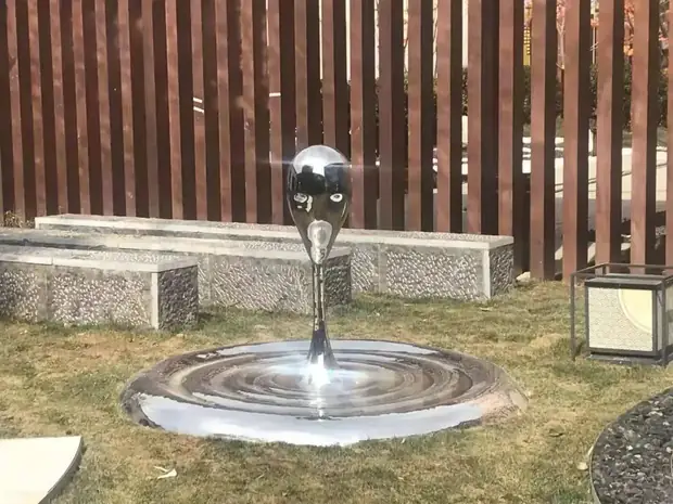Group of water dripping sculptures arranged in a sequence on a feature wall