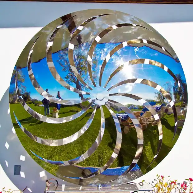 Windmill butterfly sculpture installed on a lawn with surrounding planting