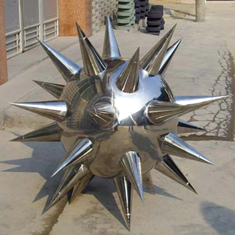 Hollow stainless steel thorn ball with mirror polished surface in a modern architectural setting