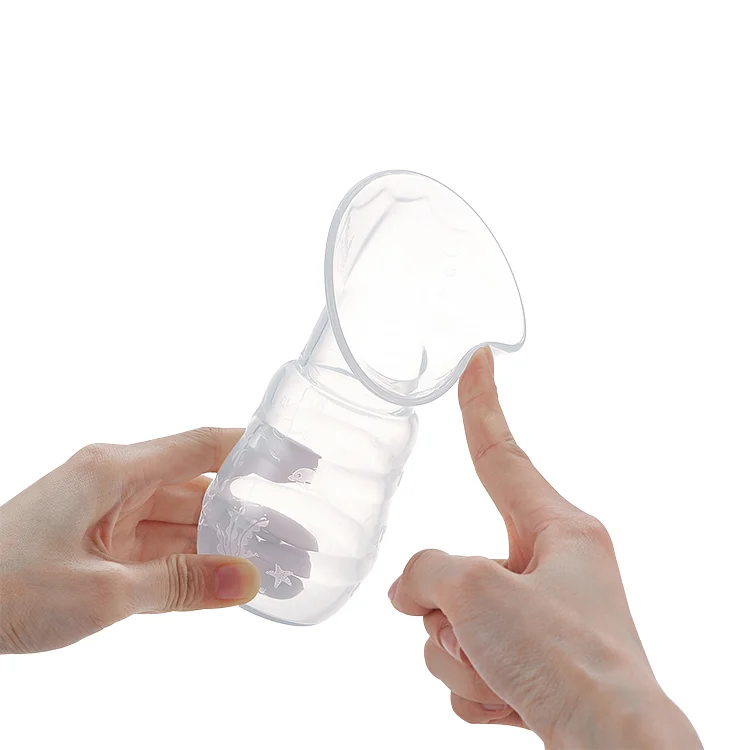 Silicone breast pump placed next to a standard baby bottle for size comparison