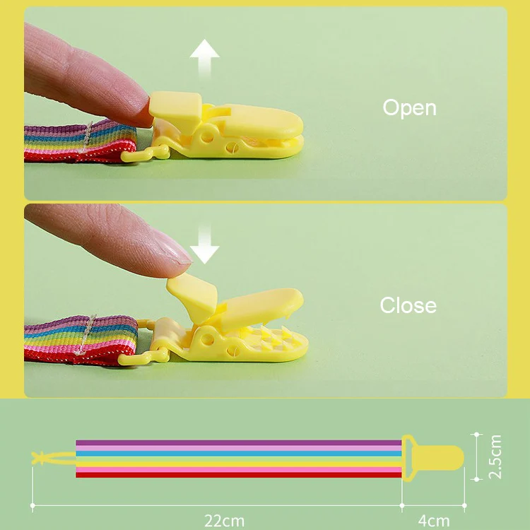 Clip attached to a baby’s bag strap with a pacifier hanging below