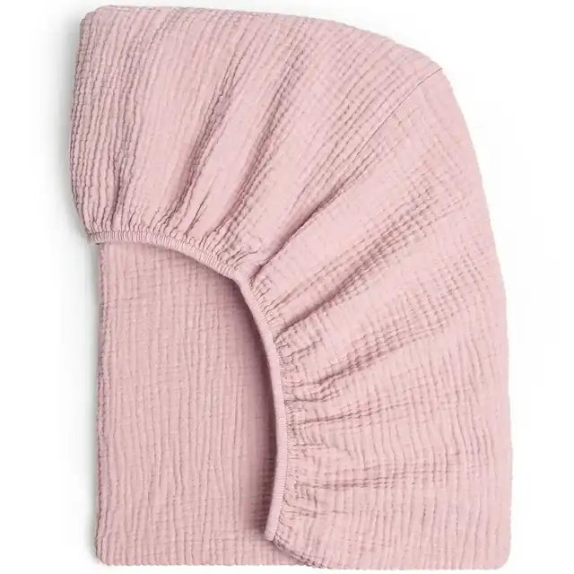 Pink 28x52 fitted crib sheet laid flat, showing elastic around all edges