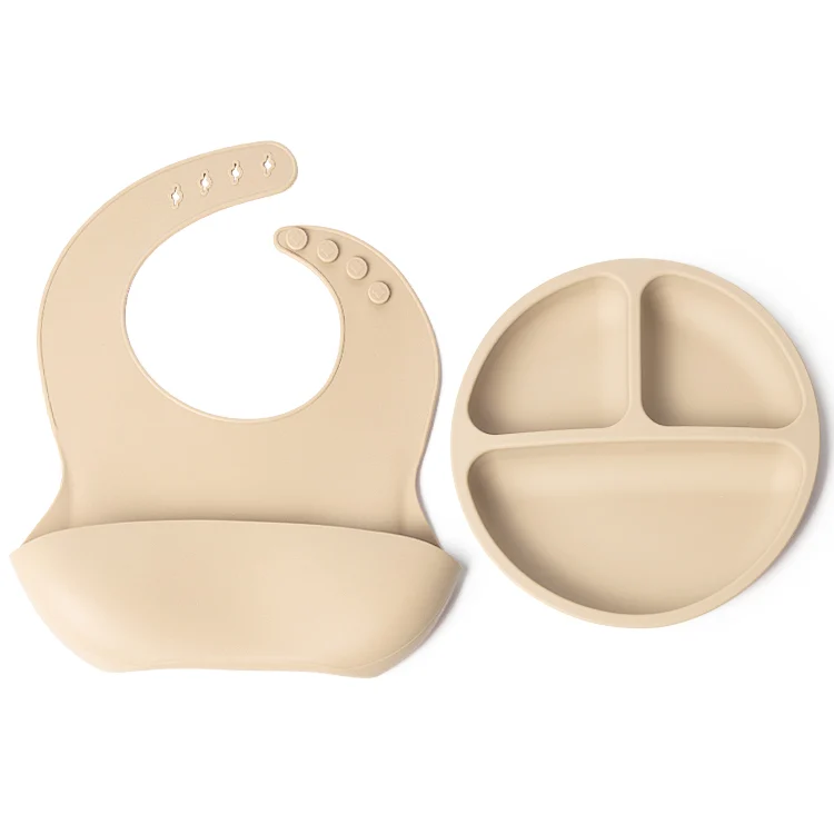 Set laid out with plate, bib, and spoon included
