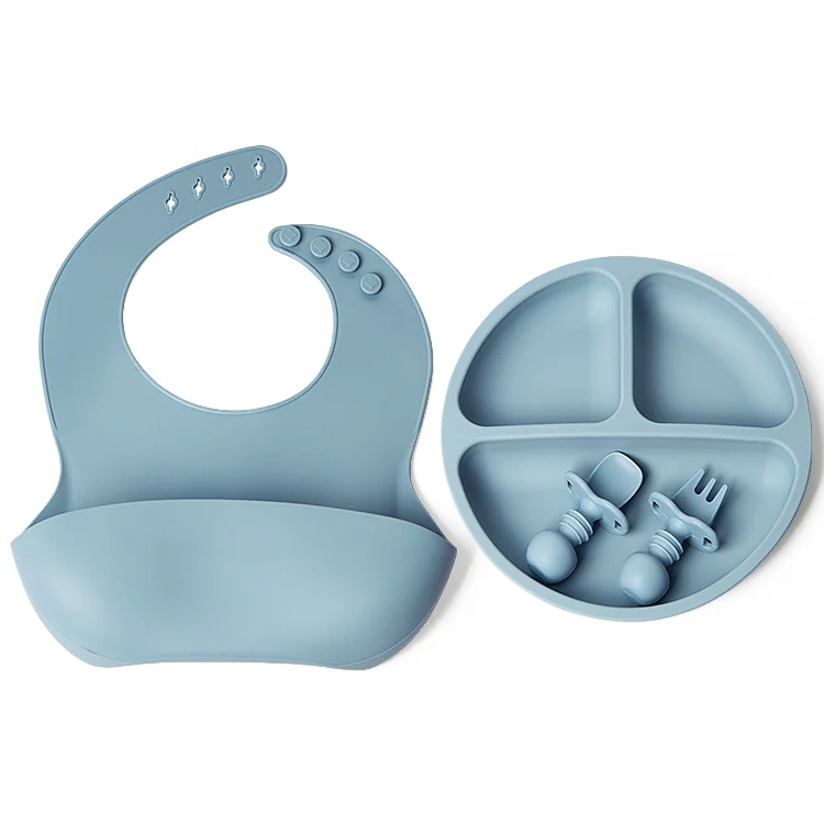Silicone baby feeding set with divided plate, adjustable bib, spoon, and fork in a single OPP bag