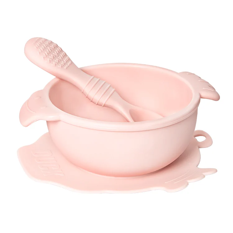 Purple duck-shaped baby bowl and spoon set with suction base on a white table