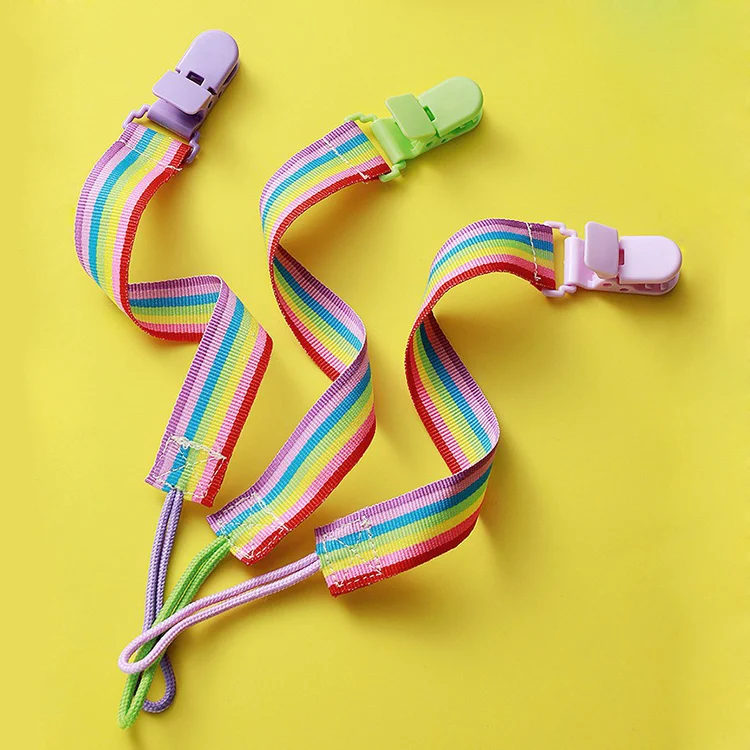 Pink nylon baby pacifier clip with a smooth ribbon and closed clip body