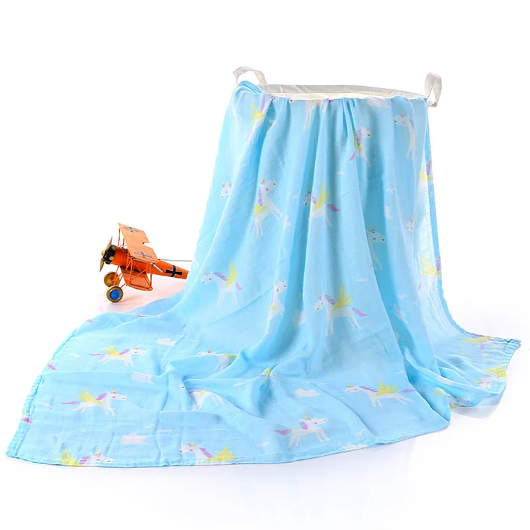 Grey bamboo cotton swaddle blanket with a baby's hand on it