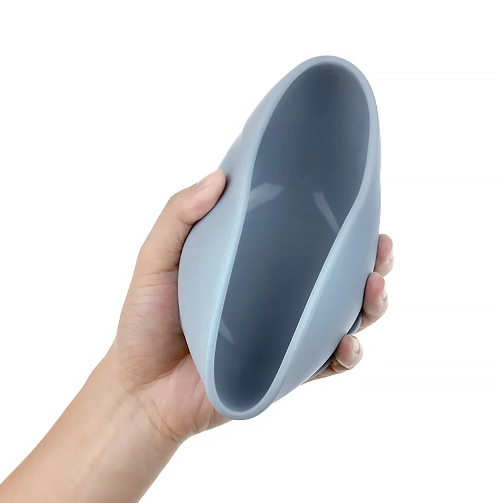 Suction bowl and spoon on a table with a baby feeding