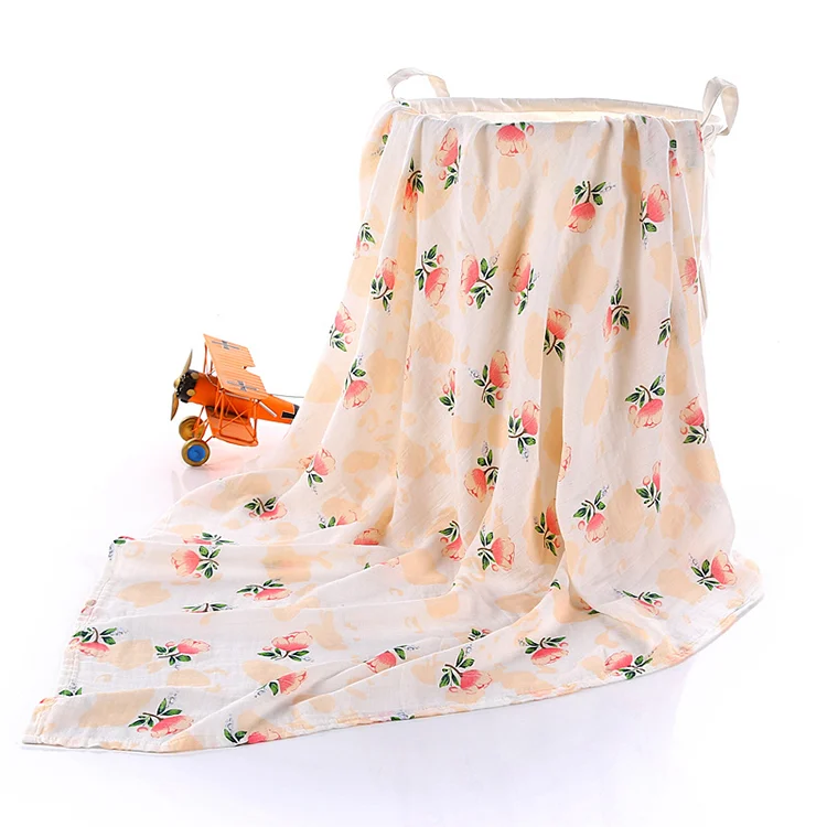 Black bamboo cotton swaddle blanket with a baby's face visible
