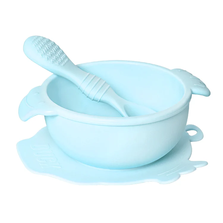 Pink duck-shaped baby bowl and spoon set with the spoon in place