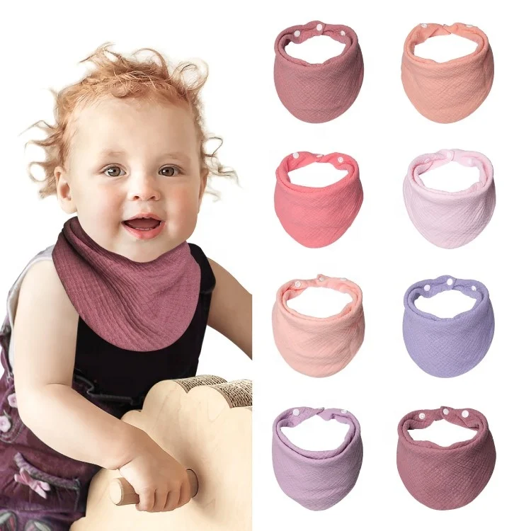 Neutral 100% muslin cotton bandana baby bib folded into a bib shape