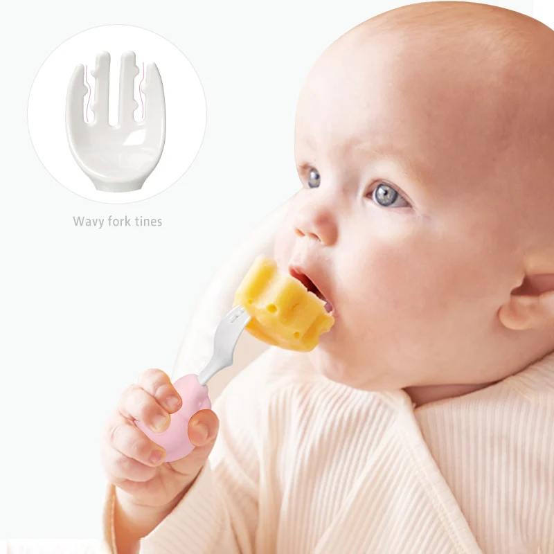 Green baby spoon and fork set with bright colours, shown with the storage box open