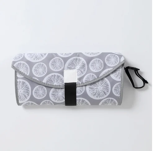 Changing pad placed on a public restroom floor with a baby on it