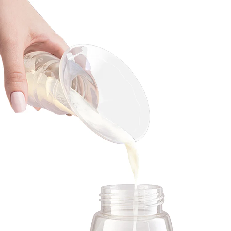 Pump in use with a hand holding it against the breast