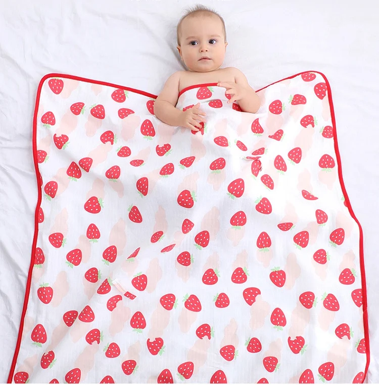 Cotton swaddle blanket used as a stroller quilt with baby inside