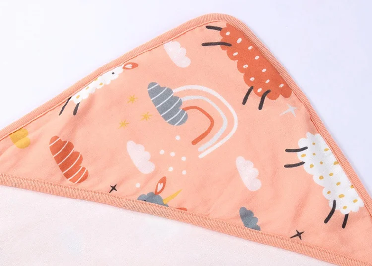 Cotton swaddle blanket displayed as a baby shower gift in a gift box