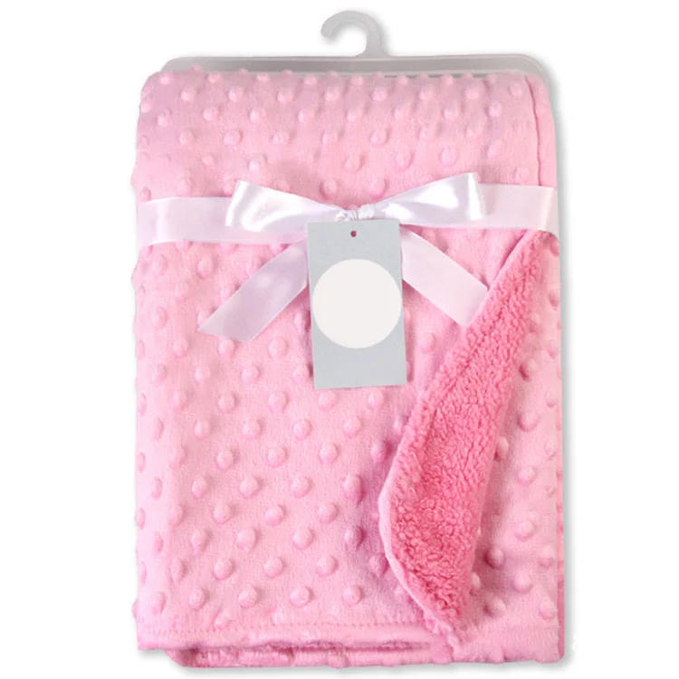 Pink newborn receiving blanket with dotted backing, unfolded and laid flat