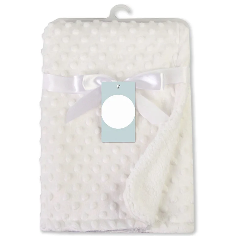 White newborn receiving blanket with microfiber texture, close-up of the dot pattern