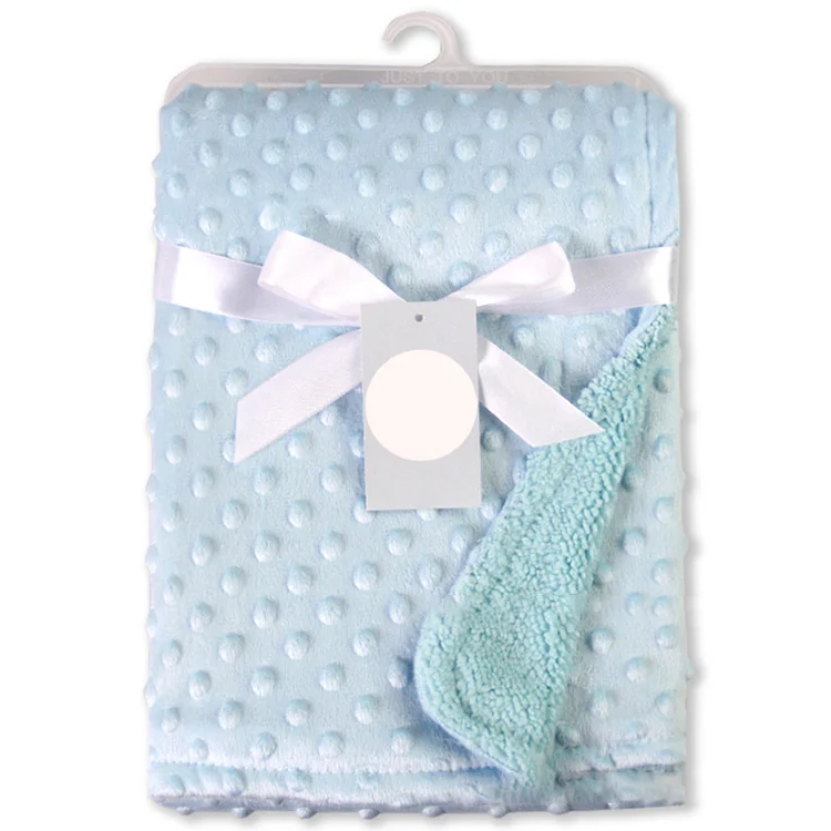 Blue newborn receiving blanket with three-dimensional dot pattern, folded in half