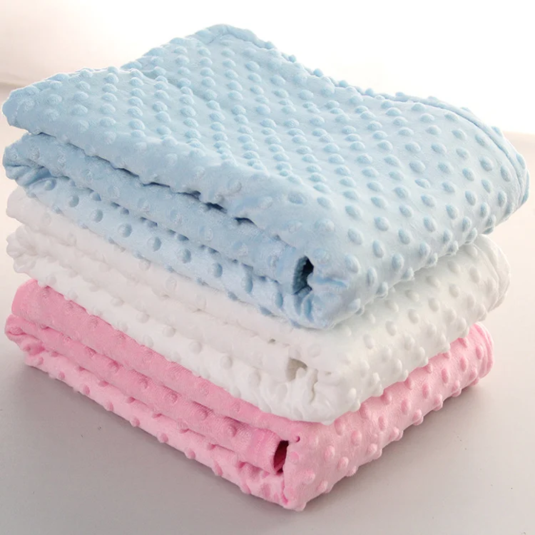 Grey newborn receiving blanket with knitted finish, shown in a folded travel position