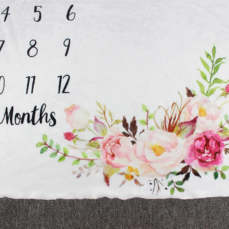 Flower blanket baby monthly milestone blanket, Size M, placed on a baby's crib