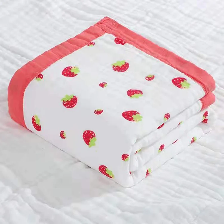 Baby blanket laid out for tummy time with a baby lying on it