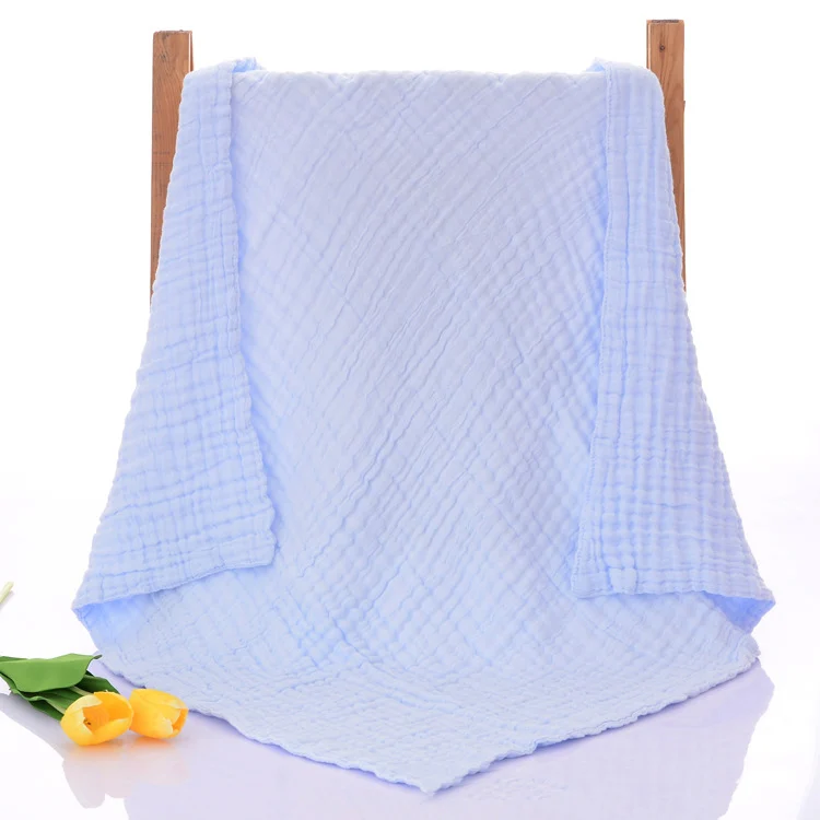 Blue 6-layer knitted baby blanket folded in thirds, ready for storage