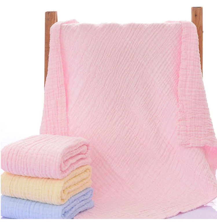 Pink 6-layer knitted baby blanket laid flat, showing texture and edges