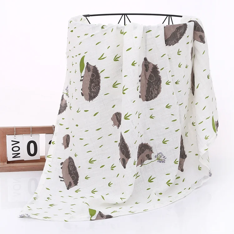 Yellow floral muslin swaddle blanket used as a nursing cover