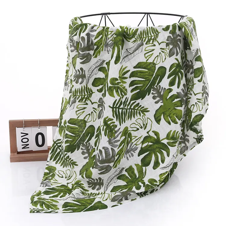Red floral muslin swaddle blanket used as a stroller cover