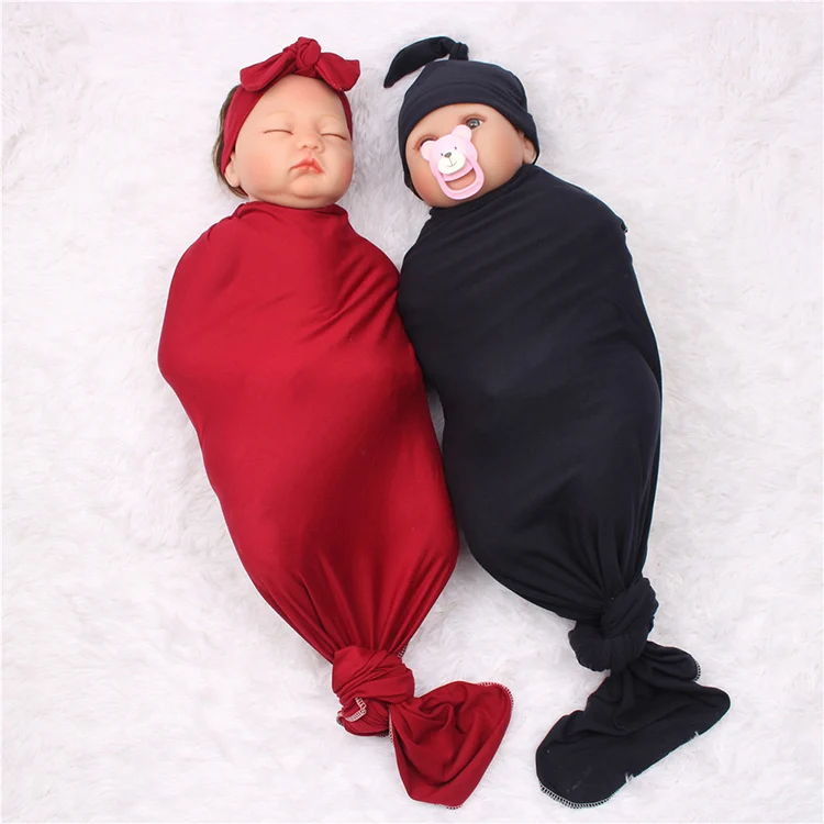 Blue 80*80cm muslin swaddle blanket with headband and hat folded neatly in a gift pack